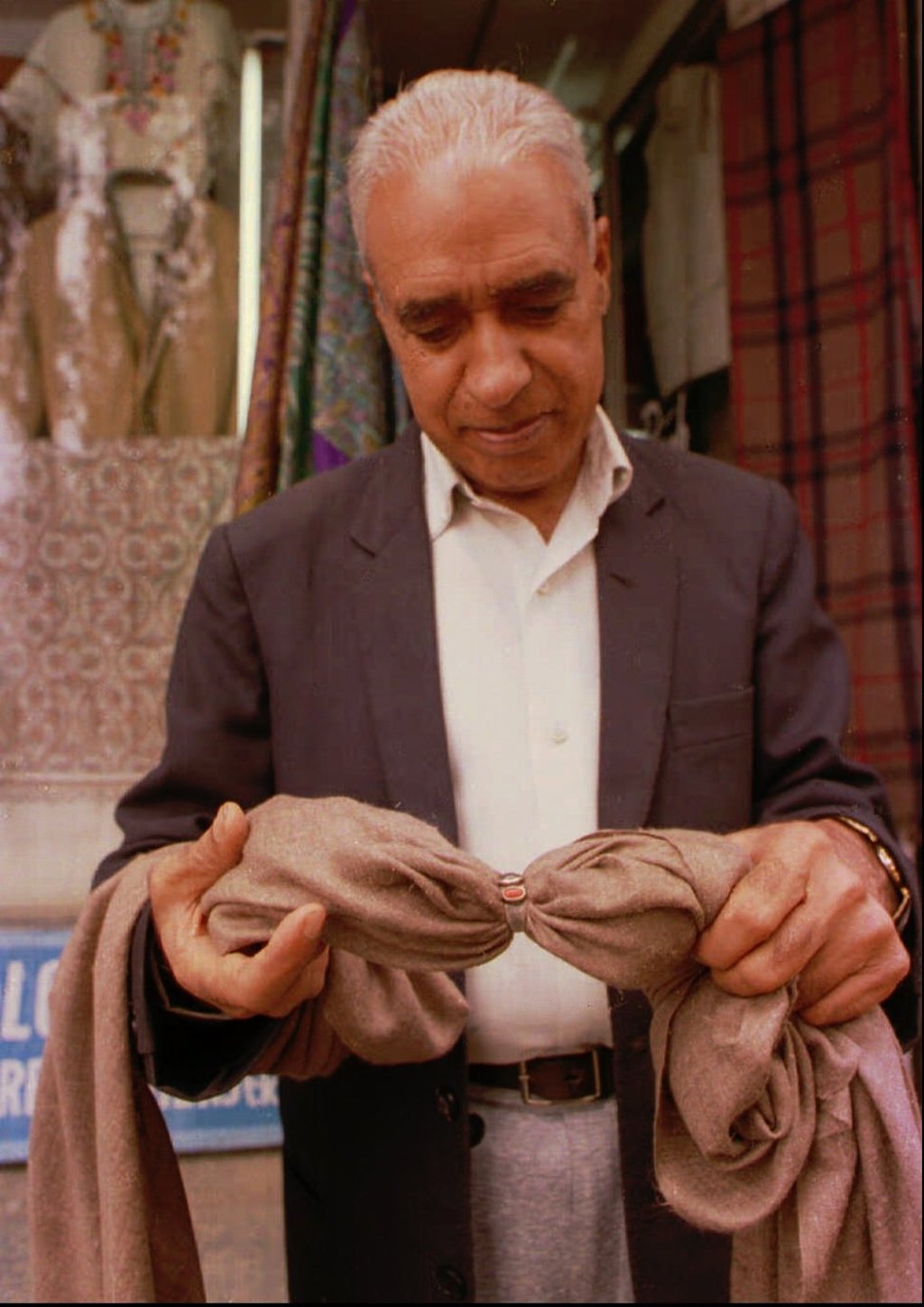A trader shows off a shahtoosh shawl in Srinagar, India in 1997. Photo: AP