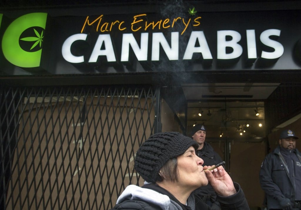A woman smokes a joint outside the Cannabis Culture shop in Vancouver. Photo: AP