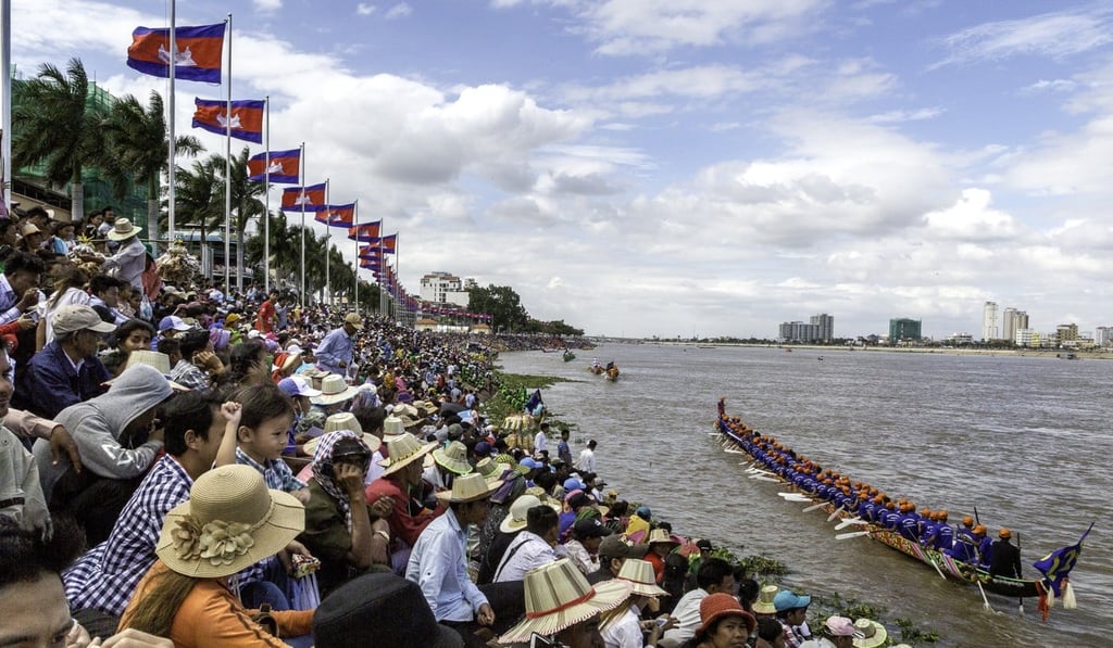 Hundreds of thousands of people watch the boat races on the Tonle Sap river in Phnom Penh, Cambodia. Photo: Omar Havana