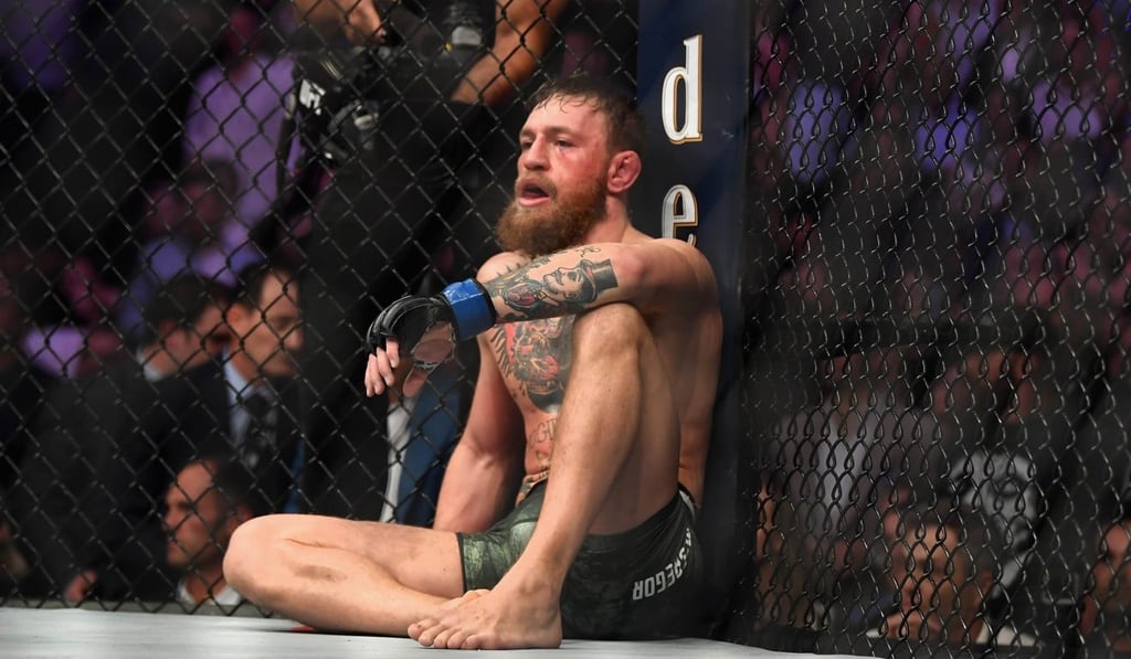 Conor McGregor sits on the mat in the octagon after being defeated by Khabib Nurmagomedov. Photo: AFP
