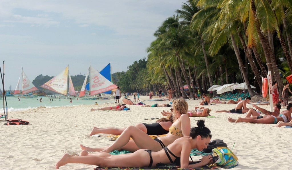 Tourists relax on a beach on Boracay. Photo: AFP