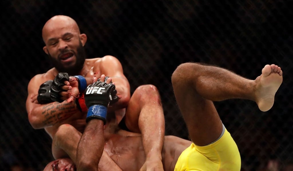 Demetrious Johnson takes down Wilson Reis during their UFC flyweight championship bout in April, 2017. Photo: AFP