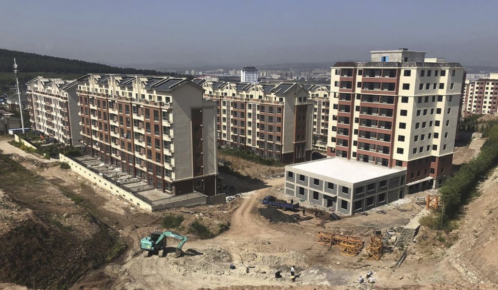 Chinese palaeontologist Xu Xing leads the team exploring the dig site next to new flats being constructed in Yanji, in the northeastern province of Jilin. Photo: AP