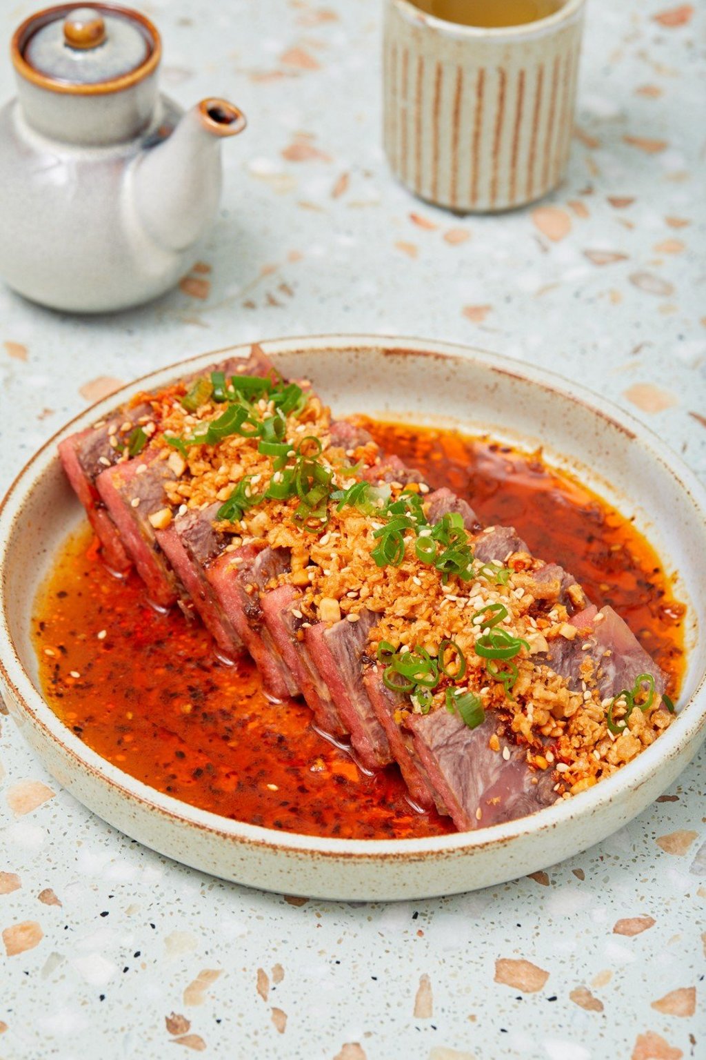 Slowcooked wagyu beef cheek is interspersed with melon slices, teasing out the chilli sauce aroma. Slowcooked wagyu beef cheek is interspersed with melon slices, teasing out the chilli sauce aroma.