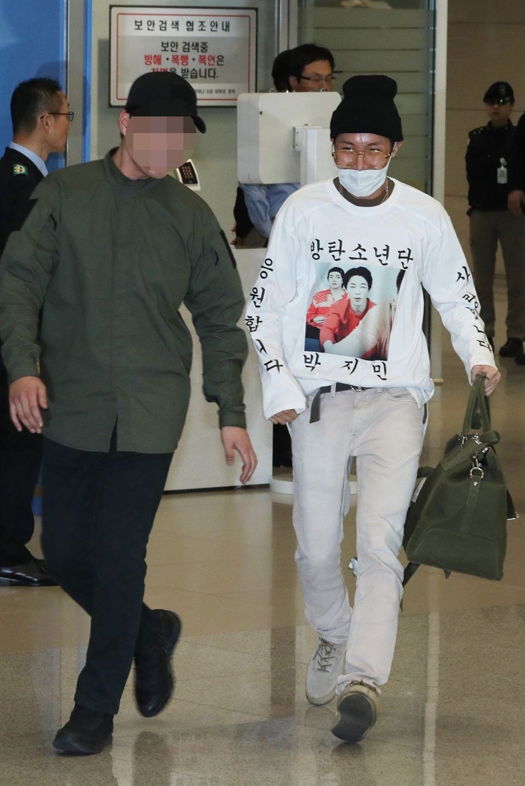 BTS’s J-Hope wears a mask and a presumably self-made shirt, featuring the image of his fellow band member Jimin alongside Korean writing. Photo: Yonhap