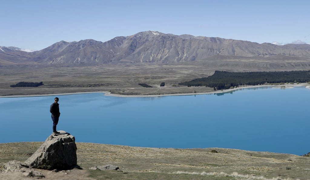 A tourist at the Mount John Observatory over looking Lake Tekapo. New Zealand’s stunning scenery attracts hikers from all over the world. Photo: AP/Mark Baker