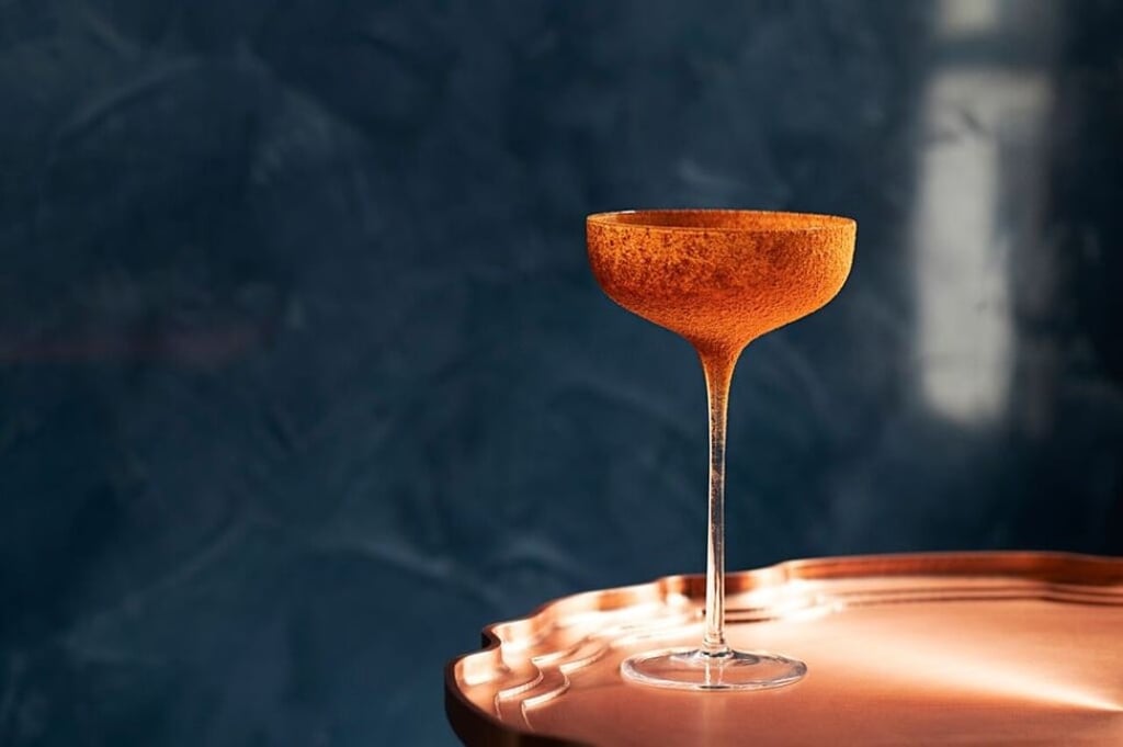 The Crown at The Dispensary features gin with Campari, lemon juice, carrot juice and Peychaud’s Bitters.