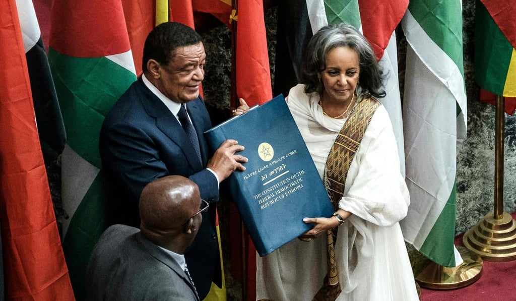 Ethiopia's first female President Sahle-Work Zewde recieves a book of the Constitution from former President Mulatu Teshomea at the Parliament in Addis Ababa on October 25. Photo: AFP