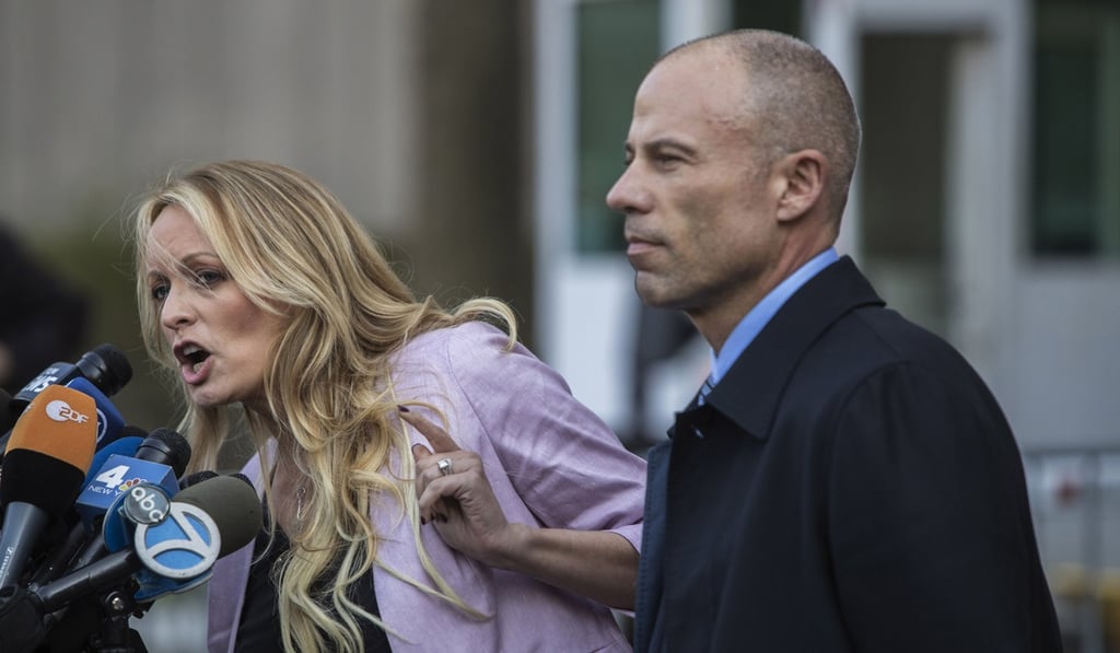 Attorney Michael Avenatti, right, listens outside Federal Court in New York as his client Stormy Daniels addresses the media on April 16, 2018. Photo: Bloomberg