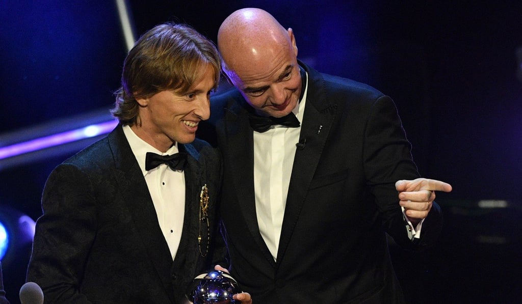 Real Madrid and Croatia player Luka Modric (L) receives the Best Fifa Men's Player award from Fifa president Gianni Infantino. Photo: EPA