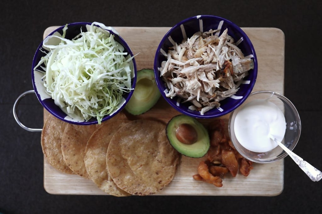 The tostada, chicken and ingredients for the filling.