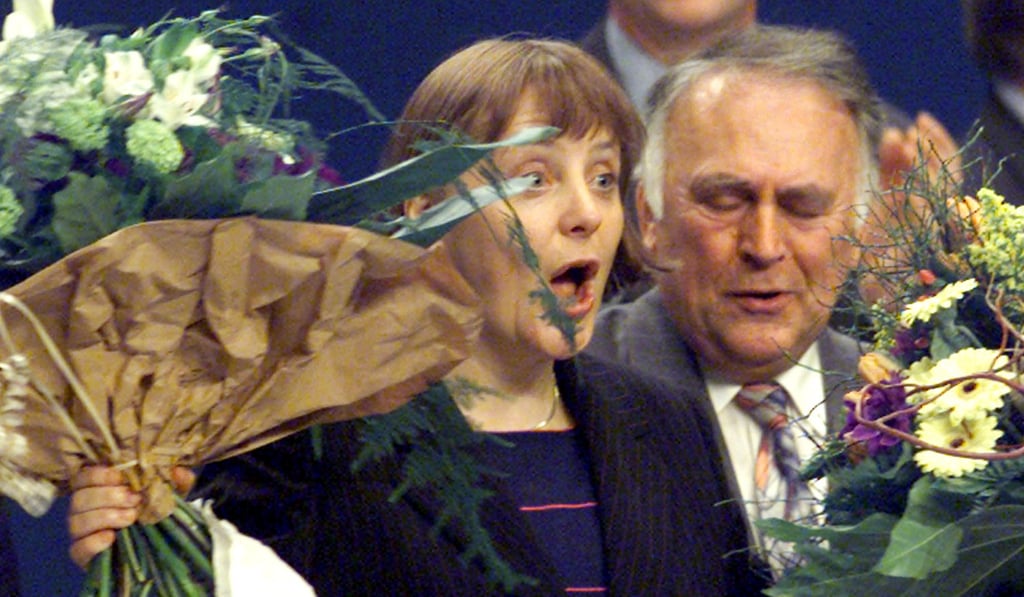 A file photo of Merkel holding flower bouquets after she was elected as the CDU’s new leader on April 10, 2000. Photo: Reuters