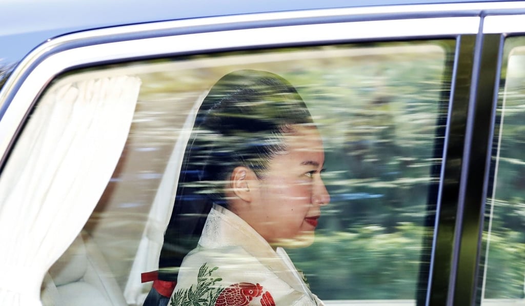 Japanese Princess Ayako, the third daughter of the late Prince Takamado, dressed in traditional ceremonial gown, is seen through a car window as she is on her way to her wedding ceremony in Tokyo. Photo: Kyodo