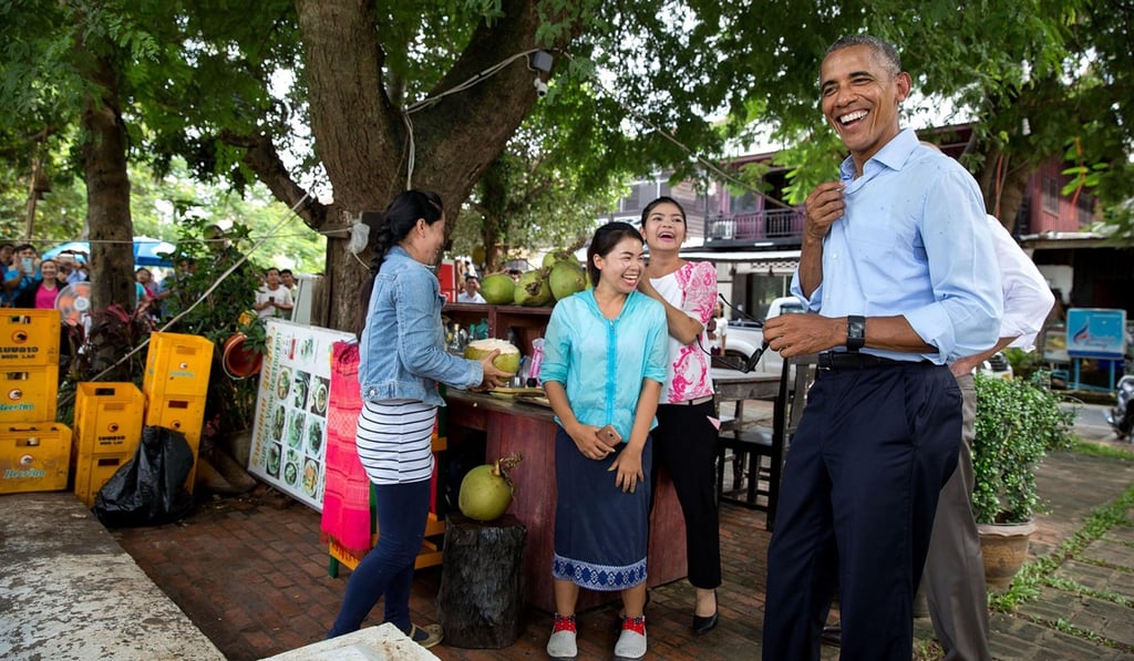 US president Barack Obama at a coconut juice stand in Luang Prabang in 2016. US president Barack Obama at a coconut juice stand in Luang Prabang in 2016.