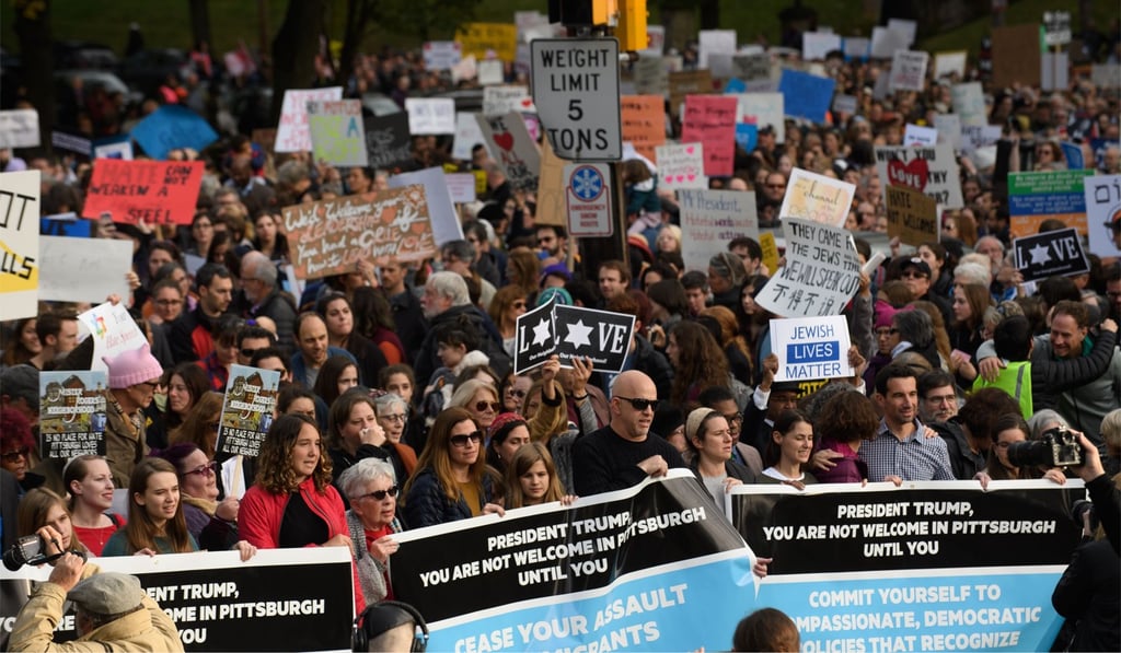An estimated 4,000 people gathered to pay tribute to victims of the Pittsburgh synagogue shootings, and protest against a visit by US President Donald Trump on Tuesday. Photo: Agence France-Presse An estimated 4,000 people gathered to pay tribute to victims of the Pittsburgh synagogue shootings, and protest against a visit by US President Donald Trump on Tuesday. Photo: Agence France-Presse