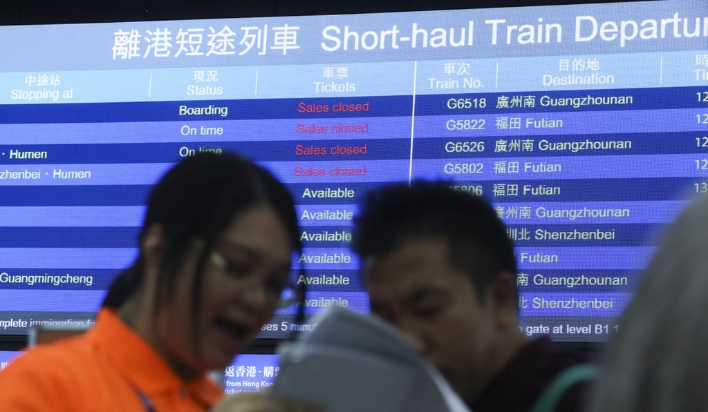 An MTR Corp employee helps a member of the public after the ticket machines broke down at West Kowloon on Wednesday morning. Photo: Sam Tsang
