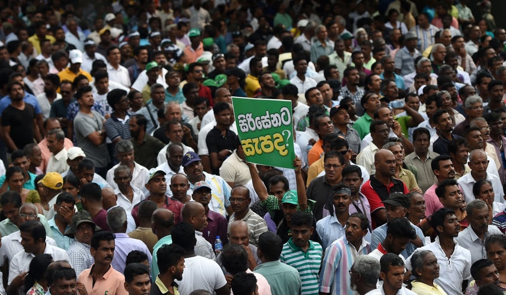Supporters of ousted Sri Lankan prime minister Ranil Wickremesinghe rally in Colombo on Tuesday. Photo: AFP