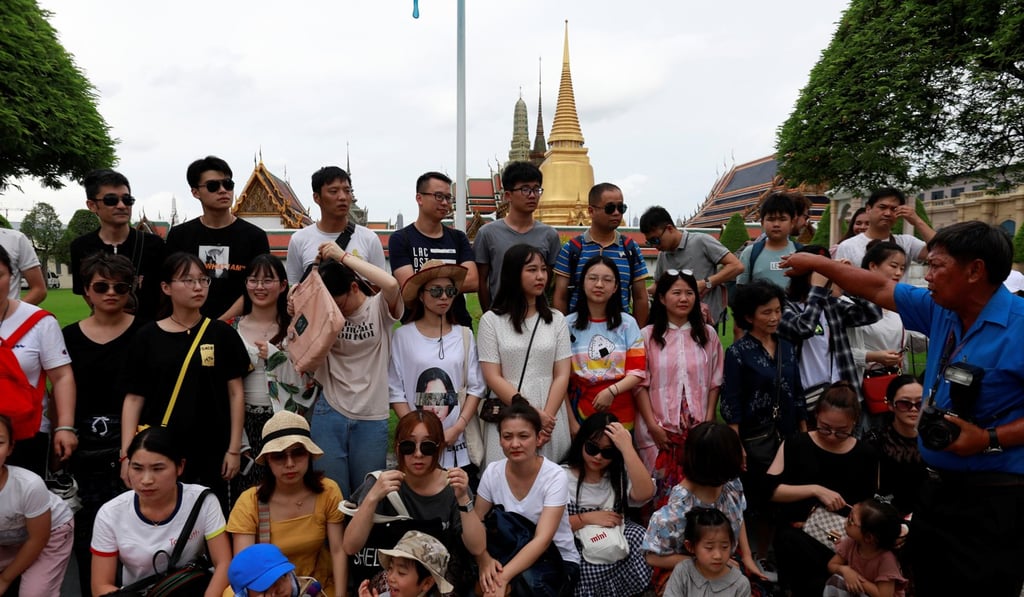 Chinese tourists visit the Temple of the Emerald Buddha in Bangkok, Thailand. The country is the most-popular overseas location for well-healed Chinese to have a holiday home. Photo: Reuters Chinese tourists visit the Temple of the Emerald Buddha in Bangkok, Thailand. The country is the most-popular overseas location for well-healed Chinese to have a holiday home. Photo: Reuters