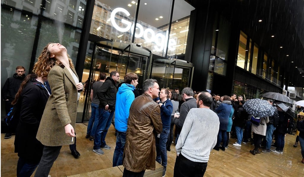 Workers stand outside the Google offices after walking out as part of a global protest over workplace issues, in London, Britain, November 1, 2018. REUTERS/Toby Melville