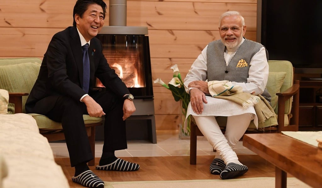 Japanese leader Shinzo Abe and Indian counterpart Narendra Modi wear slippers by the fire at Abe’s holiday home. Photo: Twitter