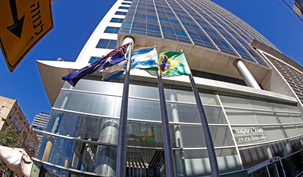 A picture taken on Sunday shows the Israeli and Brazilian flags hanging outside the building that houses the offices of the Brazilian Embassy, in the Israeli city of Tel Aviv. Photo: Agence France-Presse