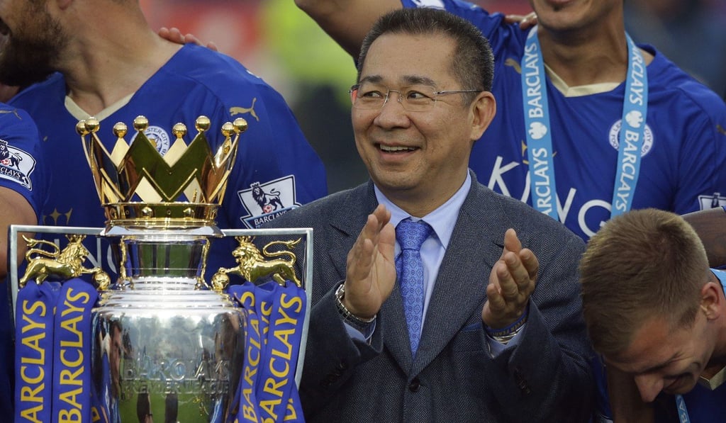 Vichai Srivaddhanaprabha applauds beside the trophy as Leicester City celebrate becoming Premier League champions in 2016. Photo: AP