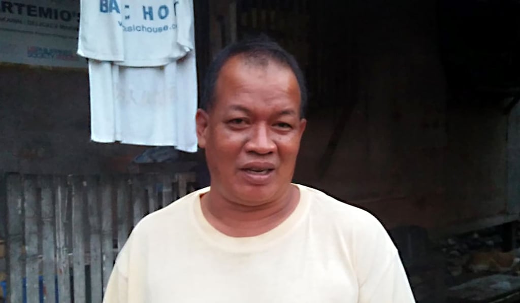 Diofel Llamado, a survivor of typhoon Haiyan, in front of his house in Tacloban City. Photo: AFP