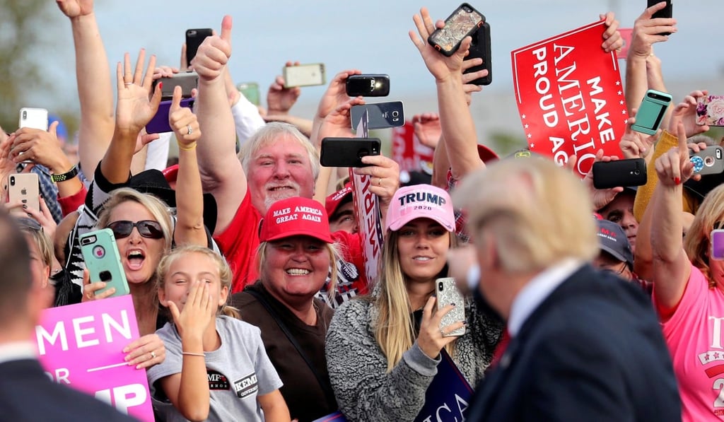 Supporters applaud US President Donald Trump as he arrives to attend a campaign rally at Middle Georgia Regional Airport in Macon, Georgia. Photo: Reuters