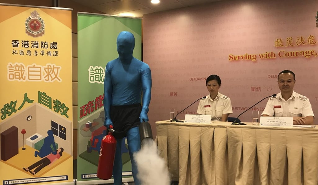 The Fire Services Department mascot “Anyone” demonstrating how to use a fire extinguisher in the event of a fire, at the launch of the department’s official Facebook page. Photo: Christy Leung