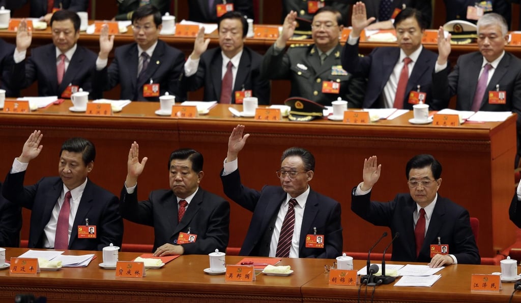 Xi Jinping (front row, left), then China's vice-president, votes with fellow party heavyweights, including President Hu Jintao (front row, right) during the 18th party congress in 2012. Photo: Reuters