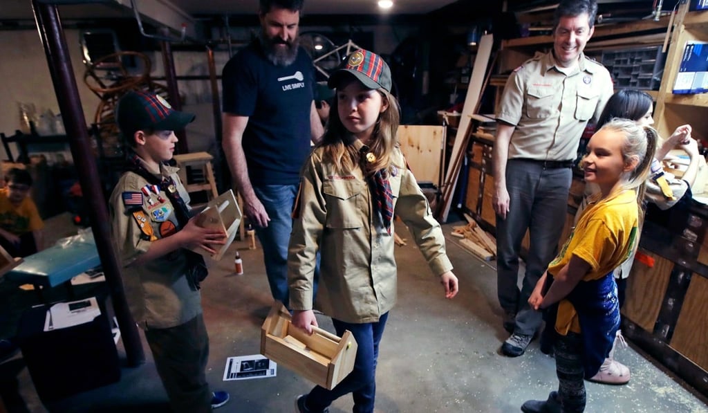 Tatum Weir (centre) carries a tool box she built as her twin brother Ian (left) follows, after a Cub Scout meeting in Madbury, New Hampshire, US. The iconic name Boy Scouts will become the gender-neutral “Scouts BSA” from February 2019, to reflect the inclusion of girls in the programme. Photo: AP