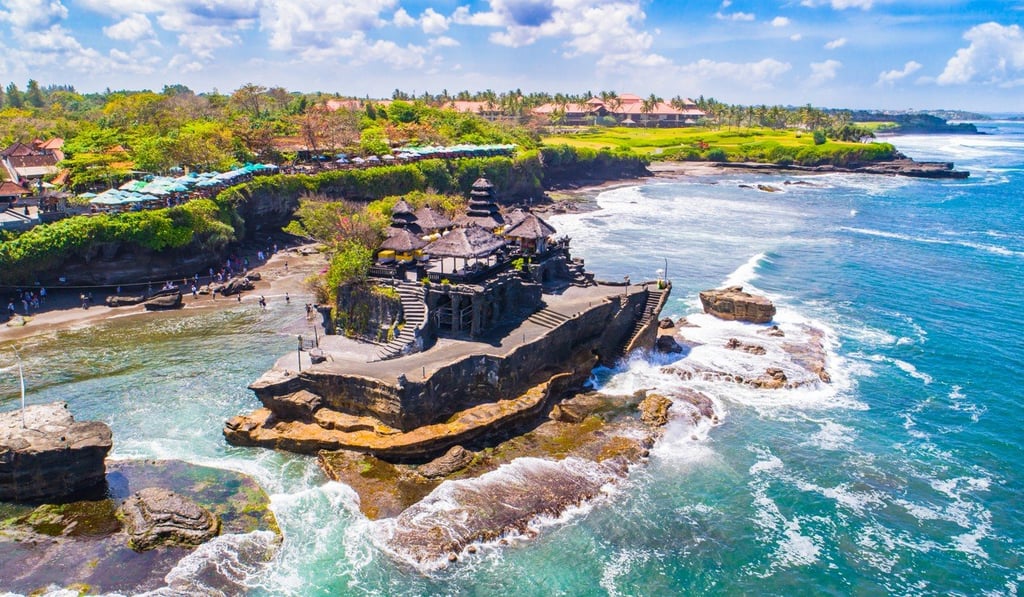 Tanah Lot temple. The red roofs behind belong to the now defunct Pan Pacific Nirwana Bali resort, where the Trump International Hotel and Tower Bali will be located. Tanah Lot temple. The red roofs behind belong to the now defunct Pan Pacific Nirwana Bali resort, where the Trump International Hotel and Tower Bali will be located.