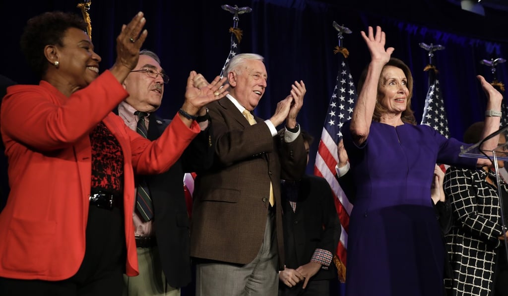 House Minority Leader Nancy Pelosi, right, and House Minority Whip Steny Hoyer, a Democrat from Maryland, second right, react to voting results during a House Democratic election night event in Washington on Tuesday. Photo: Bloomberg