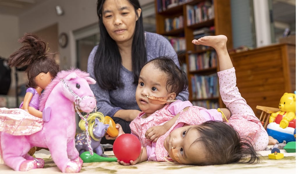 Bhumchu Zangmo watches her conjoined twins Nima and Dawa play at Miracle sMiles Retreat in East Kilmore, Australia, on Friday. Photo: EPA Bhumchu Zangmo watches her conjoined twins Nima and Dawa play at Miracle sMiles Retreat in East Kilmore, Australia, on Friday. Photo: EPA