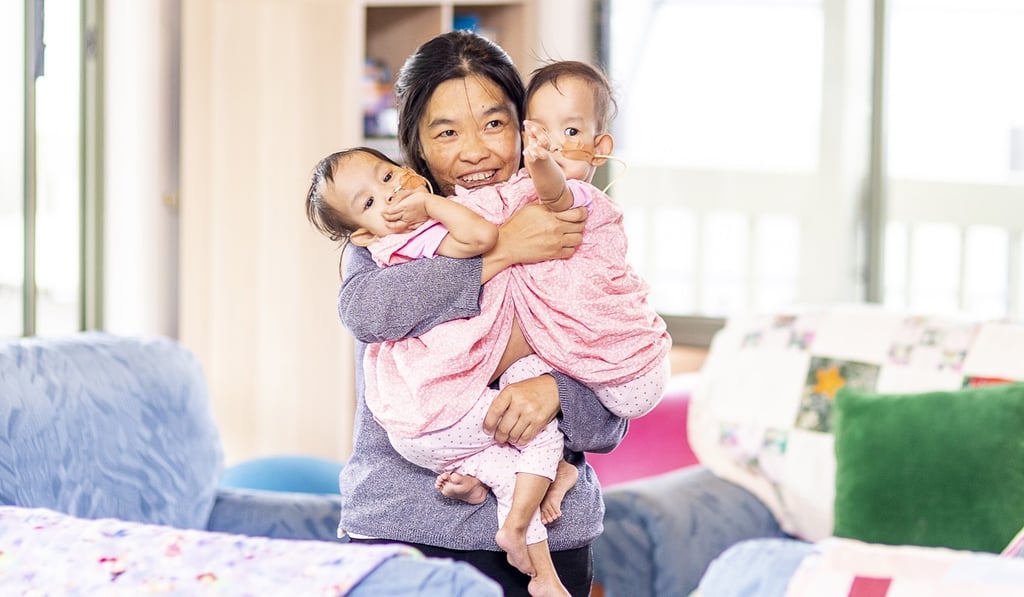 Bhumchu Zangmo hugs her twins Nima and Dawa at Miracle sMiles Retreat in East Kilmore, Australia, on Friday. Photo: EPA Bhumchu Zangmo hugs her twins Nima and Dawa at Miracle sMiles Retreat in East Kilmore, Australia, on Friday. Photo: EPA