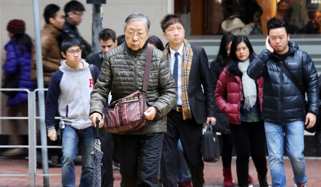 An elderly woman crosses the street in Wan Chai in January 2016. Cross-generational co-living could be a win-win option for both the elderly and young people in Hong Kong. Photo: Dickson Lee