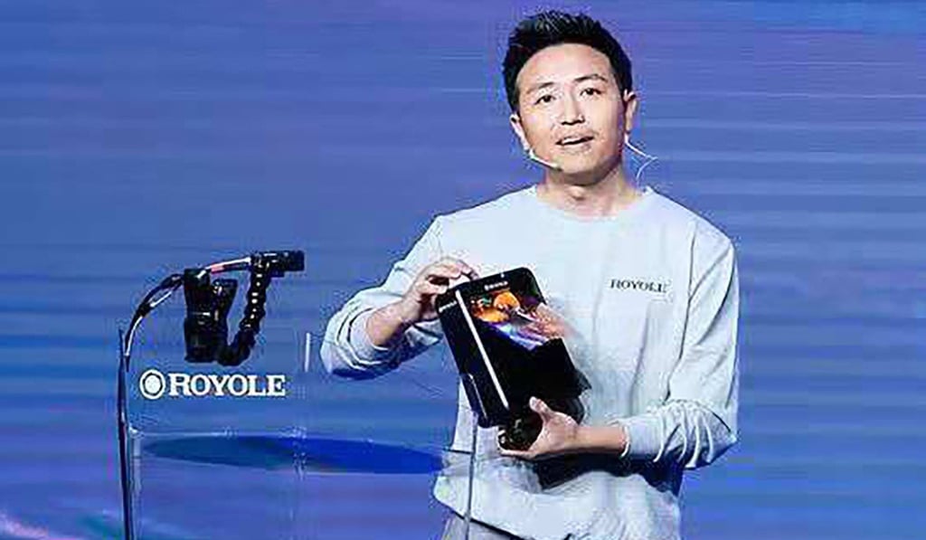 Bill Liu Zihong, co-founder and CEO of Shenzhen start-up company, Royole Corp, holds up its foldable FlexPai smartphone.