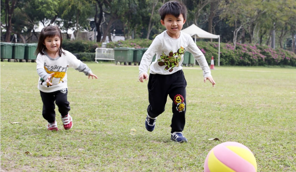 Marsha and Marcus Chan have fun on the grass in Victoria Park, Causeway Bay. Photo: Nora Tam