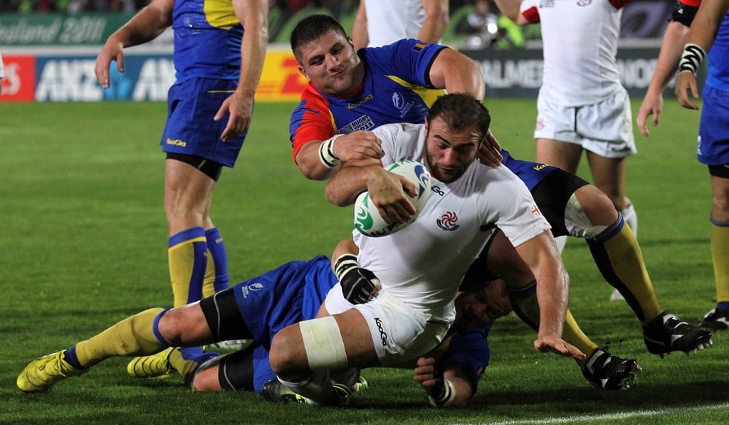 Mamuka Gorgodze of Georgia (front) scores a try as he is tackled by Paulica Ion of Romania during the 2011 Rugby World Cup. Photo: Agence France-Presse PHOTO / Marty Melville