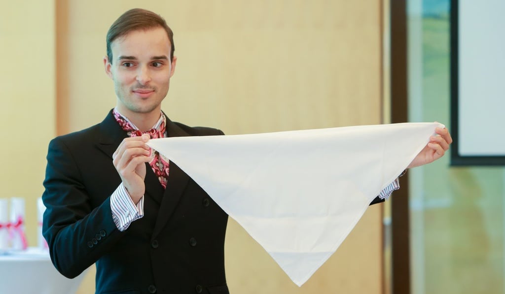 De Bernadac shows how to fold a handkerchief. Photo: courtesy of Guillaume Rué de Bernadac