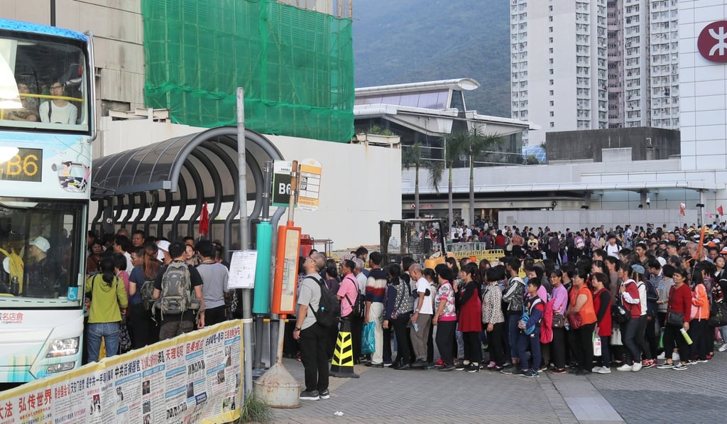 Mainland tourists wait for a bus in Tung Chung. Photo: SCMP