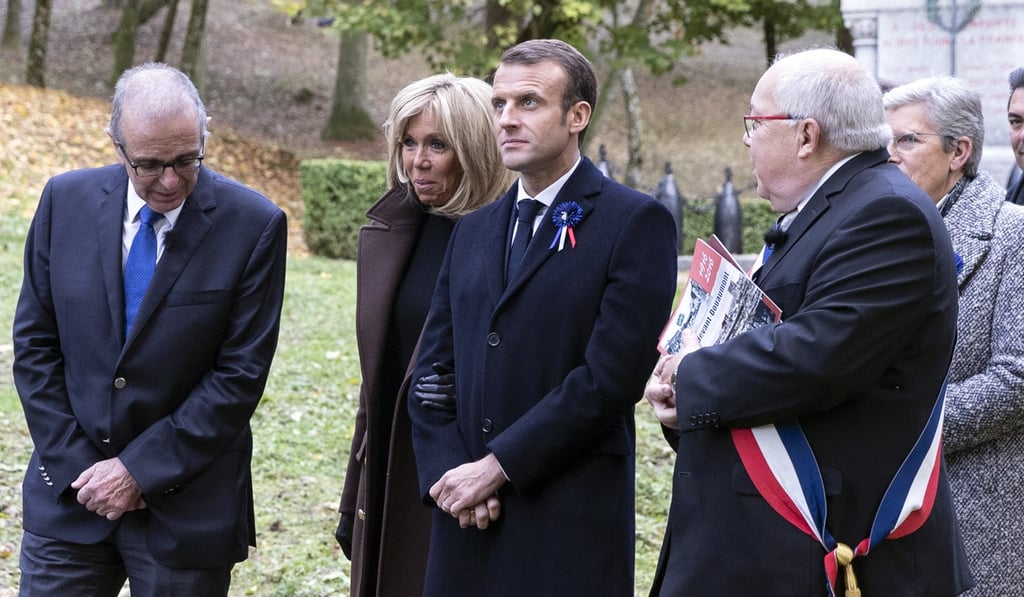 French President Emmanuel Macron and his wife Brigitte Macron walk with officials and students to the Douamont National Necropolis and Ossuary as part of ceremonies marking the centenary of the first world war, near Verdun, eastern France on November 6, 2018. Photo: EPA