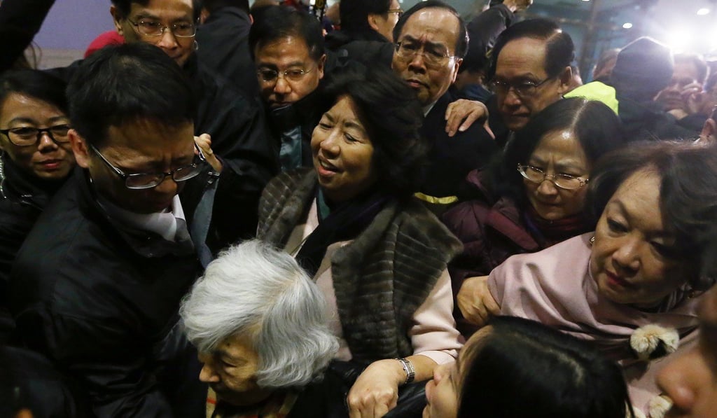 Students protest outside a HKU council meeting as Leonie Ki (centre) is caught in the surging crowd. Photo: Sam Tsang