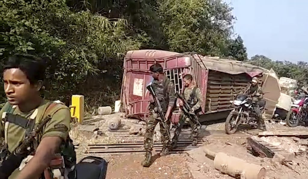 Paramilitary soldiers pass the remains of a bus blown up by Maoist rebels in Chhattisgarh state on Thursday. Photo: KK Productions/AP Paramilitary soldiers pass the remains of a bus blown up by Maoist rebels in Chhattisgarh state on Thursday. Photo: KK Productions/AP