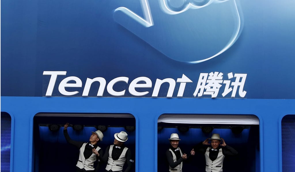 Dancers perform underneath the logo of Tencent at the Global Mobile Internet Conference in Beijing. Photo: Reuters