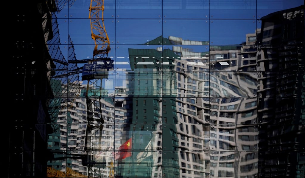 A residential building reflected on a glass wall in Beijing, China. Photo: Reuters