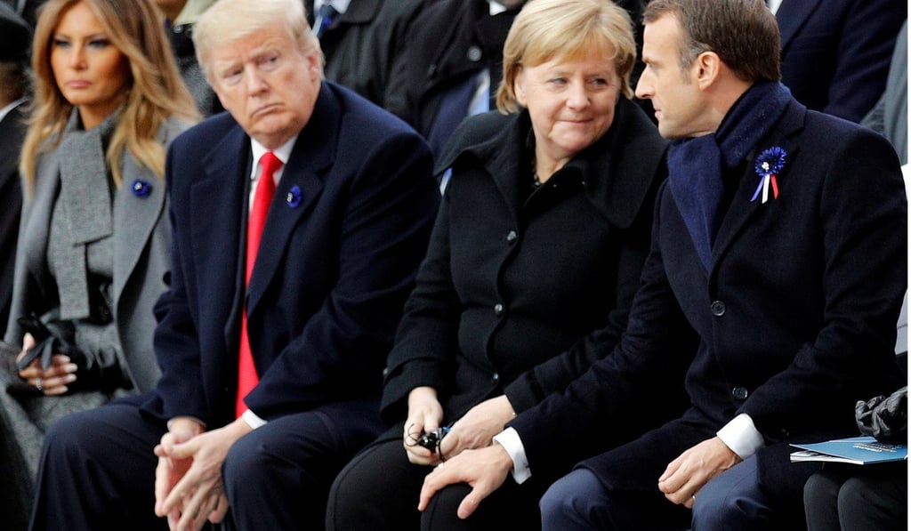 US President Donald Trump watches French President Emmanuel Macron putting his hand on German Chancellor Angela Merkel’s knee during the commemoration ceremony at the Arc de Triomphe in Paris on November 11, 2018. Photo: Reuters