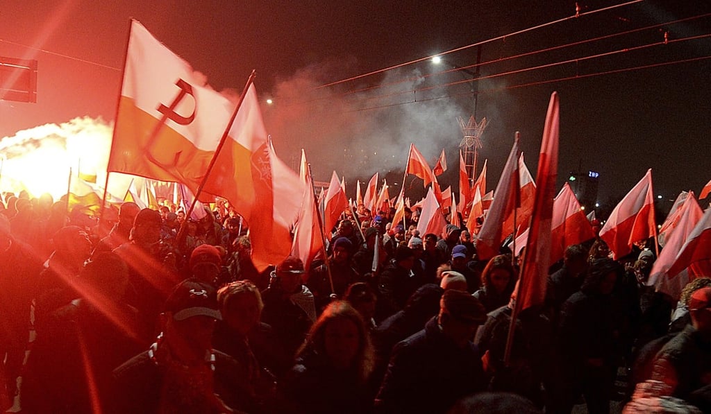 Marchers burn flares as they take part in the annual March of Independence organised by far right activists to celebrate 100 years of Poland's independence marking the nation regaining its sovereignty at the end of first world war after being wiped off the map for more than a century, in Warsaw, Sunday November 11, 2018. Photo: AP Photo