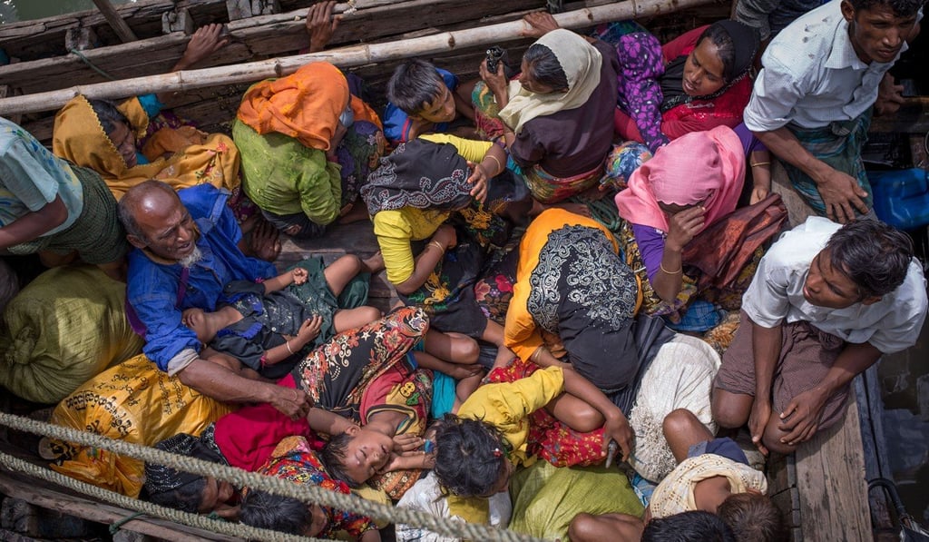 Rohingya refugees arrive by boat on the Bangladesh side of the Naf River after fleeing violence in Myanmar. Photo: AFP
