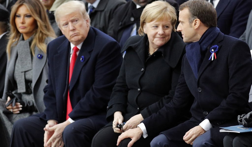 Trump watches French President Emmanuel Macron putting his hand on German Chancellor Angela Merkel’s knee during ceremonies at the Arc de Triomphe in Paris on November 11, 2018. Photo: EPA